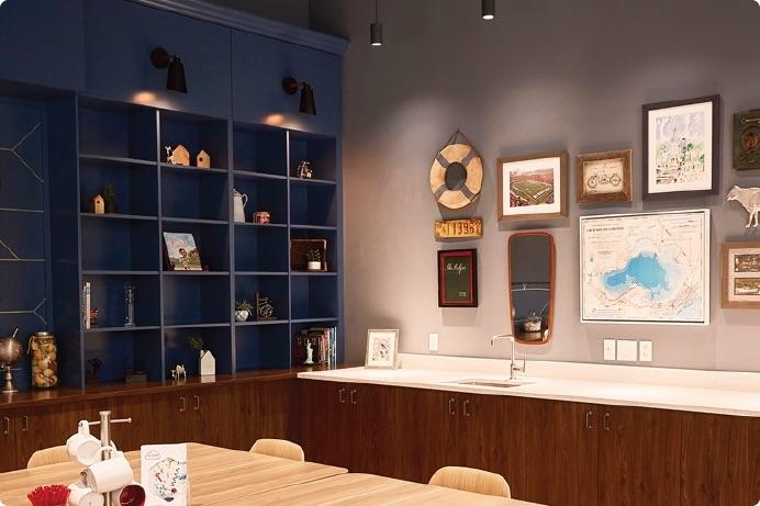 a room with a blue cabinet and pictures on the wall