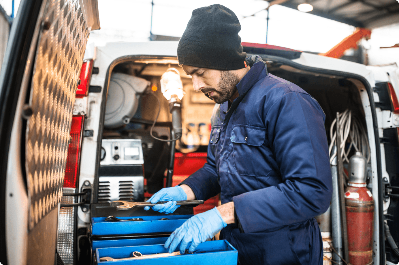 A man getting tools out of a van