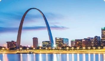 a large arch in front of Gateway Arch