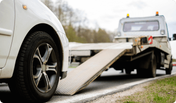 a car being driven onto a tow truck