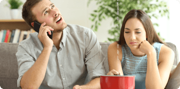 couple watching a leak fall into a bucket