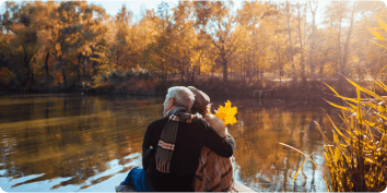 a couple looking over a lake