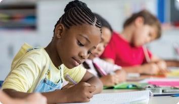 a few children studying in a classroom