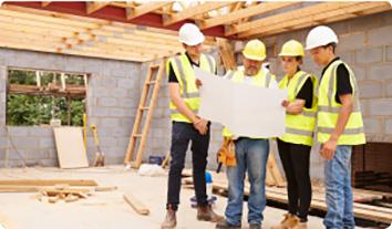 a group of men wearing hardhats and holding a sign