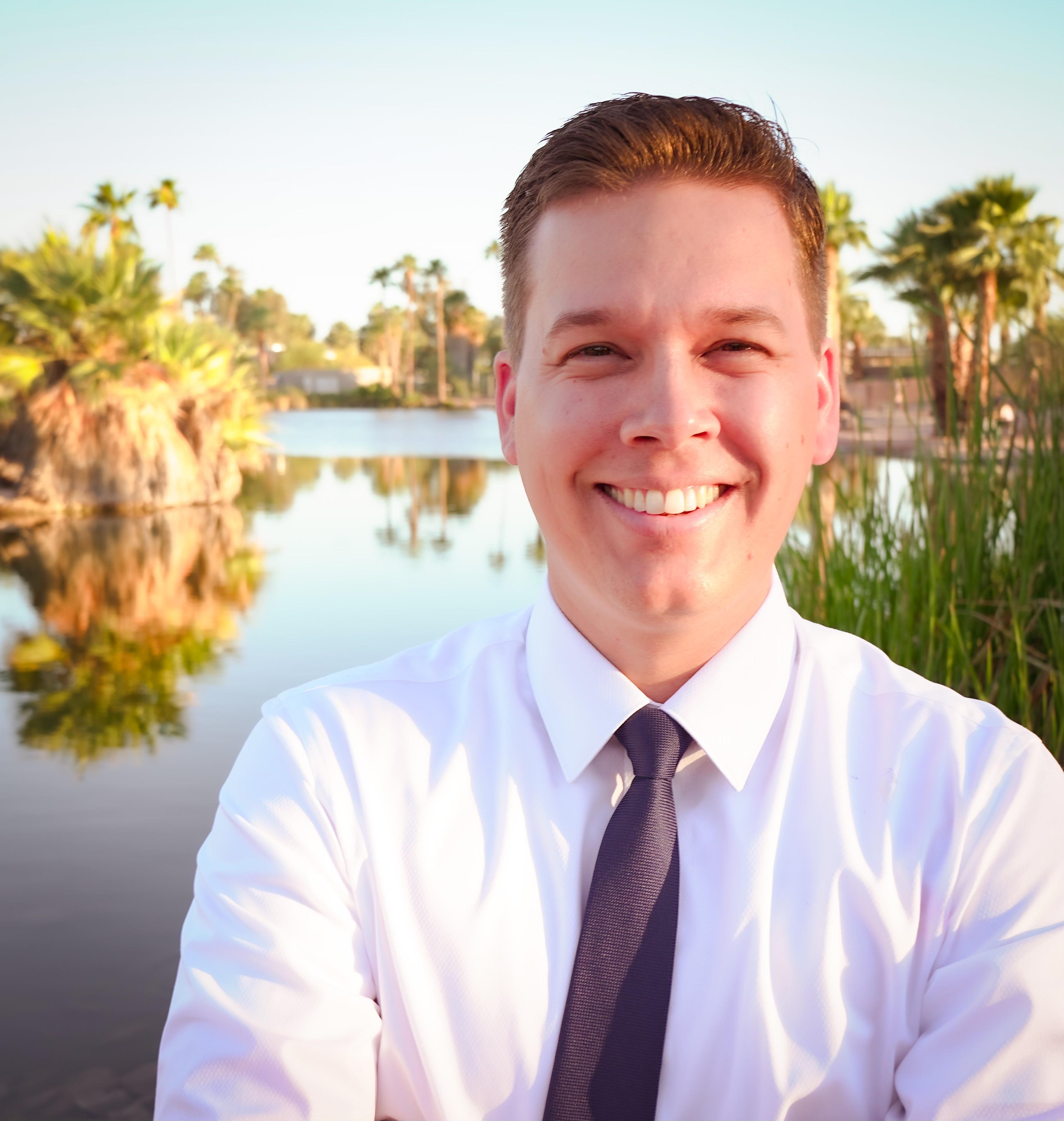 a man in a tie smiling