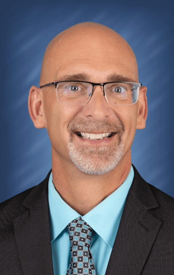 a man wearing glasses and a suit