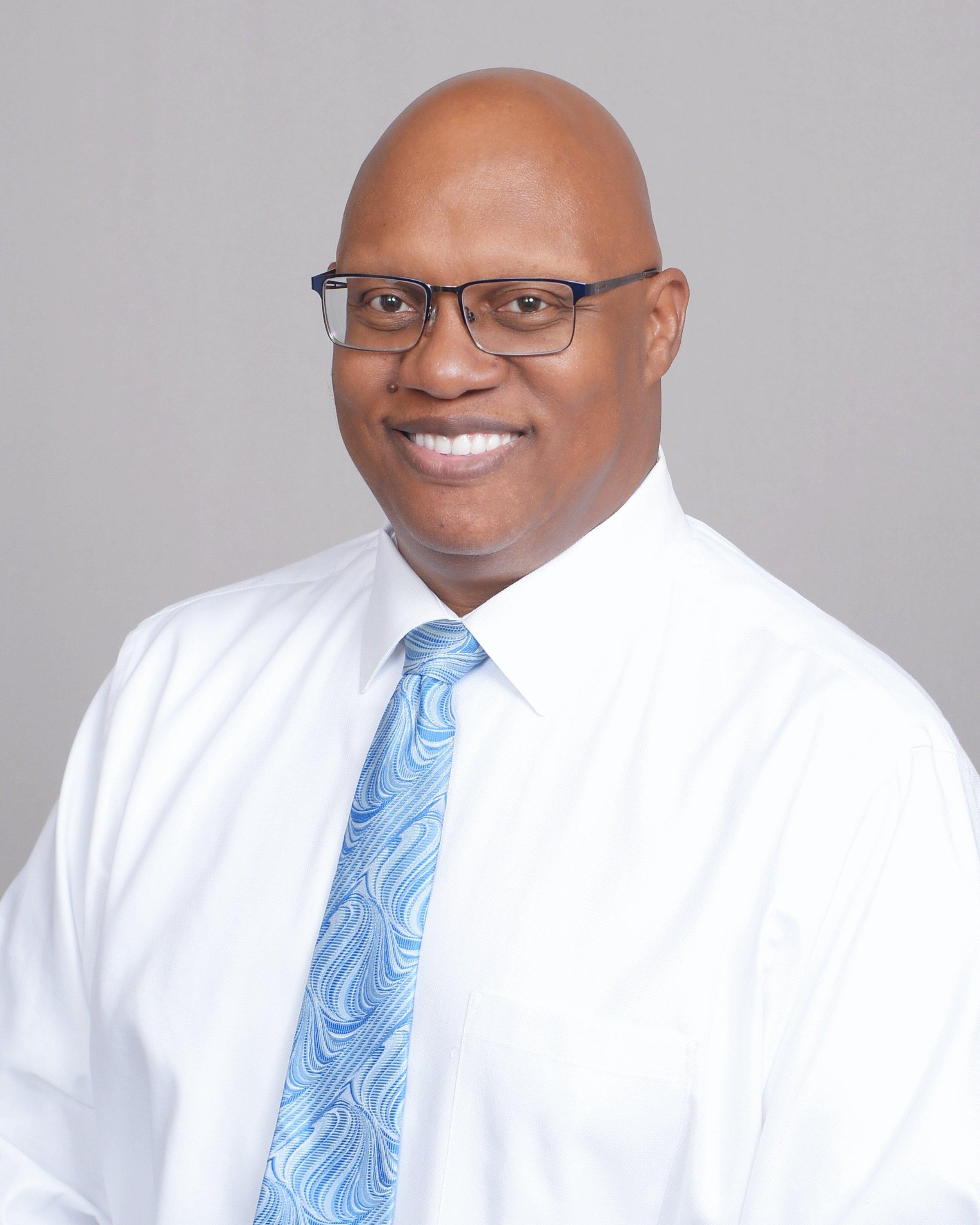 a man wearing glasses and a tie