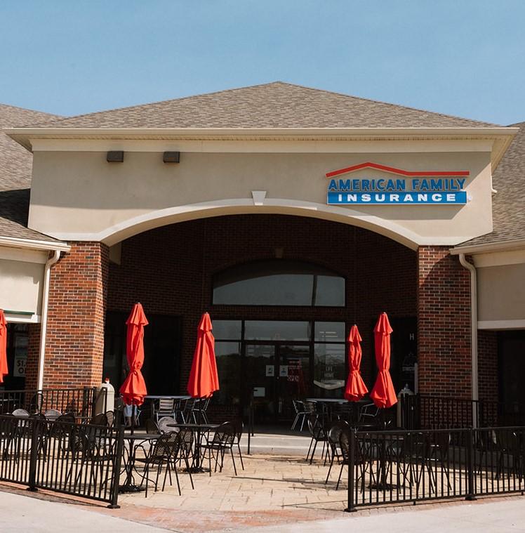 a restaurant with umbrellas outside