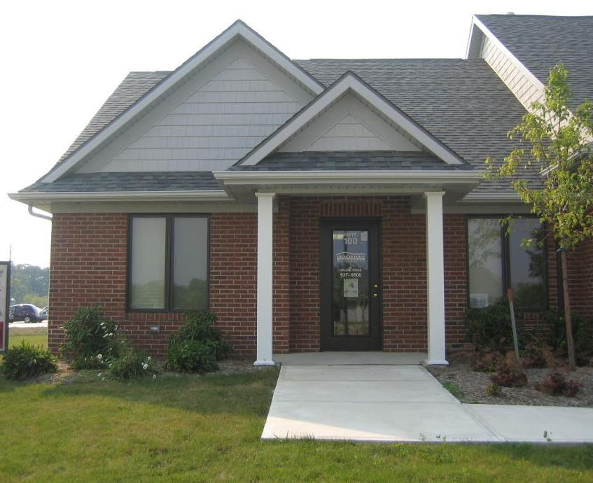 a brick house with a white pillar