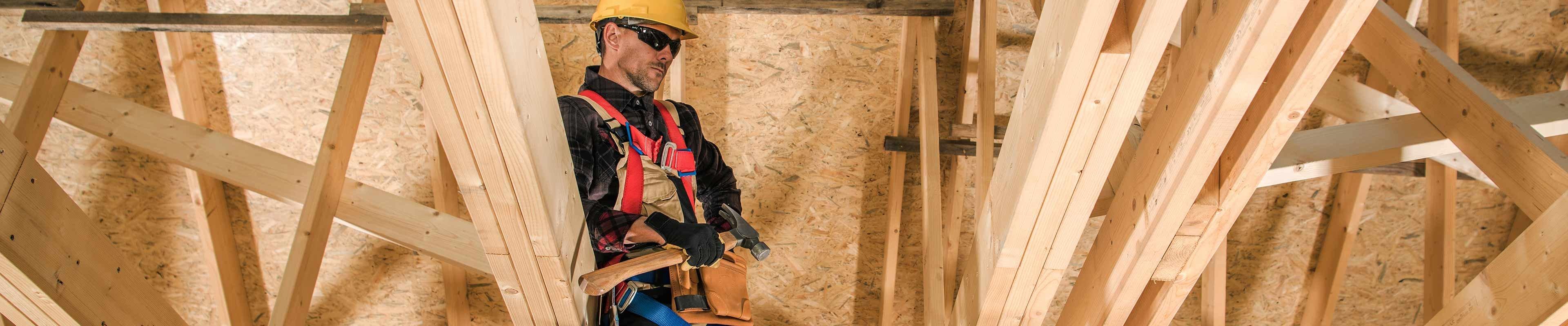 Image of a contractor rebuilding an attic after a storm.