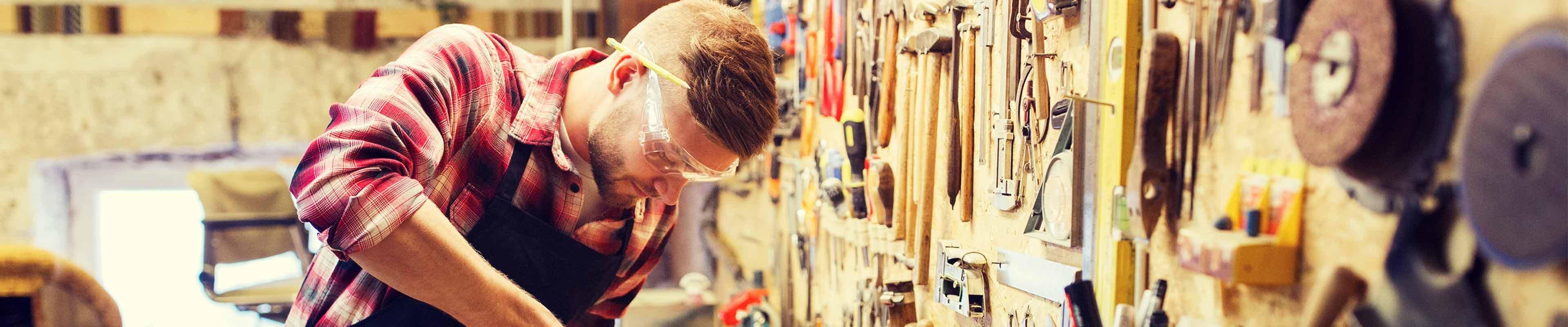 A man working on a project in his garage workshop.