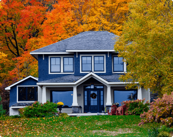 A large home surrounded by fall foliage.