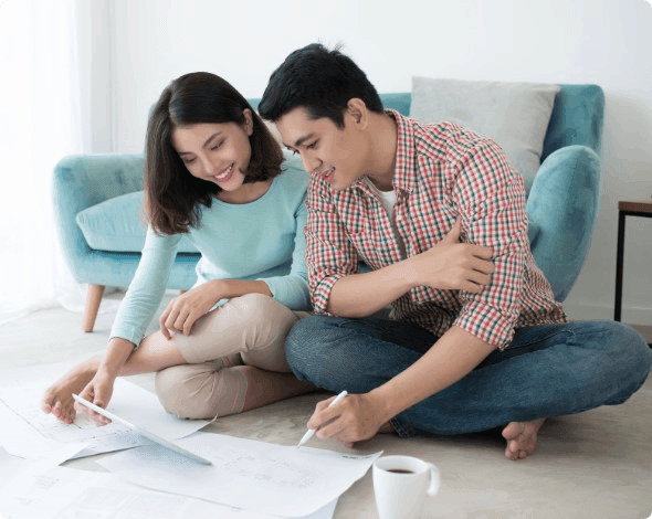 A happy couple looking at home blueprints.