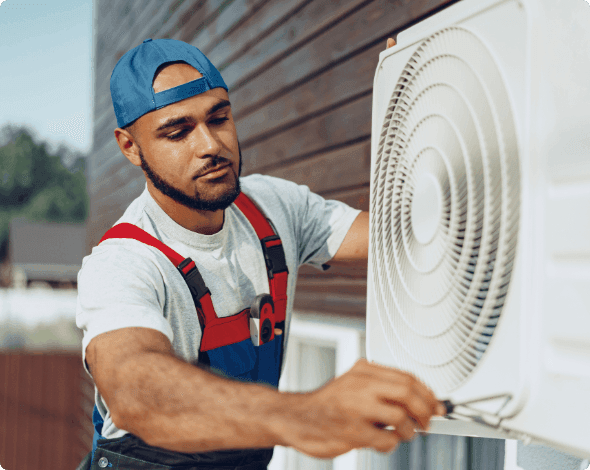 Worker fixing a home air conditioning unit. 