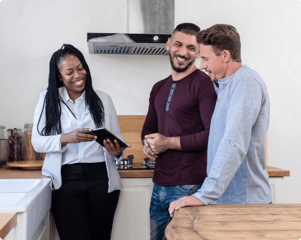 Landlord showing a happy couple a home rental.