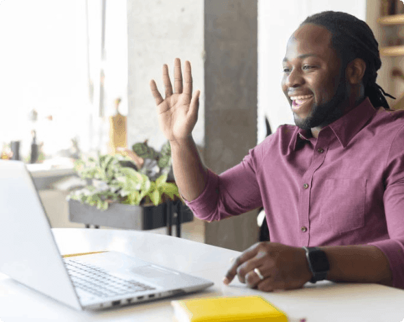 Leader waiving to his coworkers during a remote meeting. 