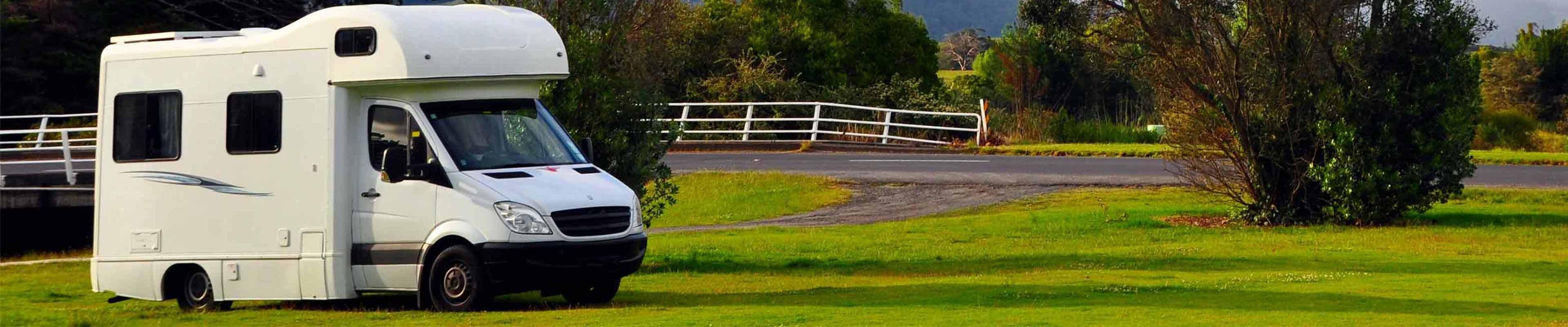 An RV parked on grass.