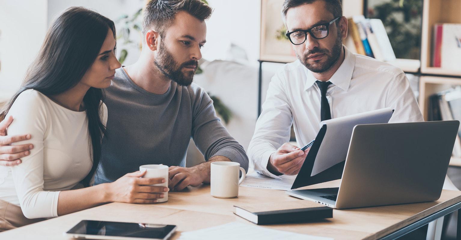 Young couple with agent getting a personal insurance review