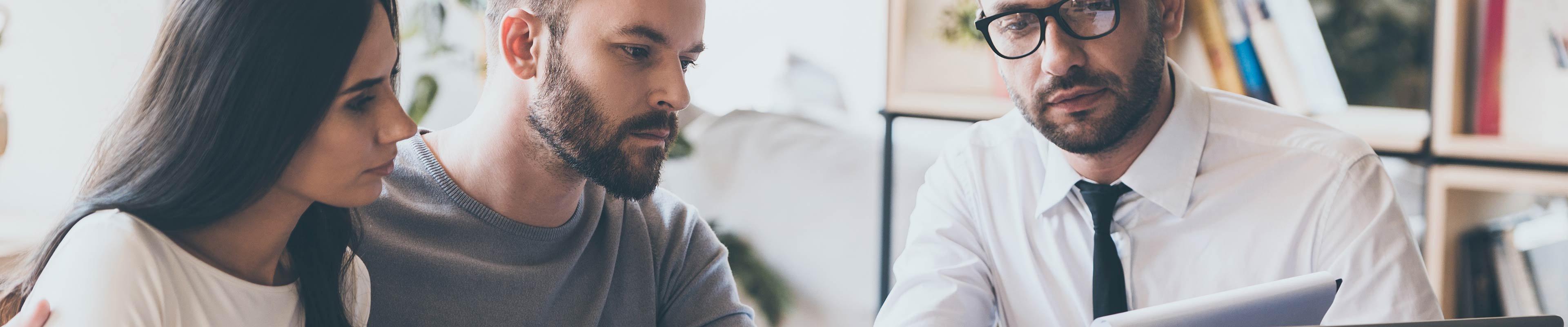 Young couple with agent getting a personal insurance review