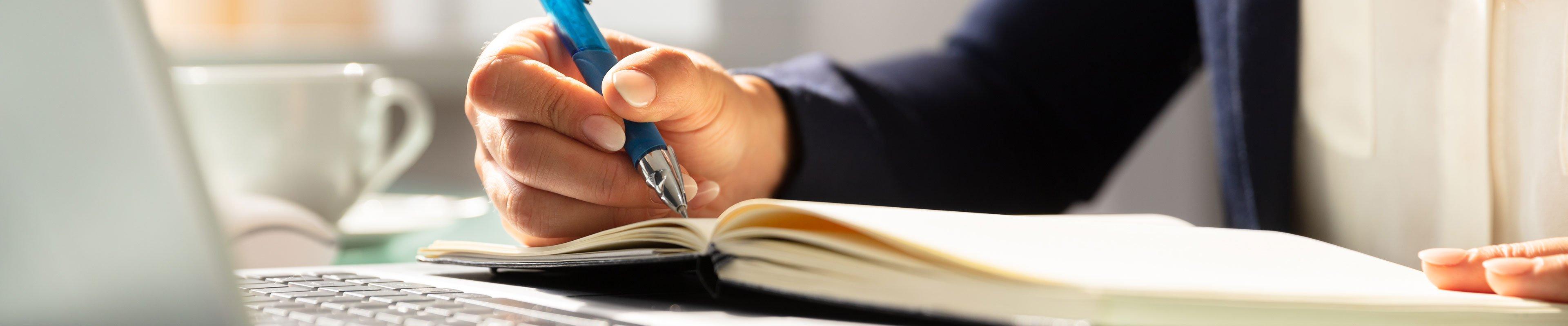 a person writing on a book