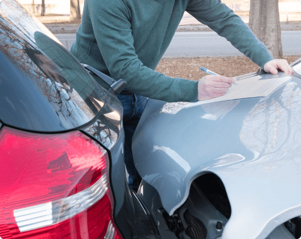 Man filling out information after being in a car accident