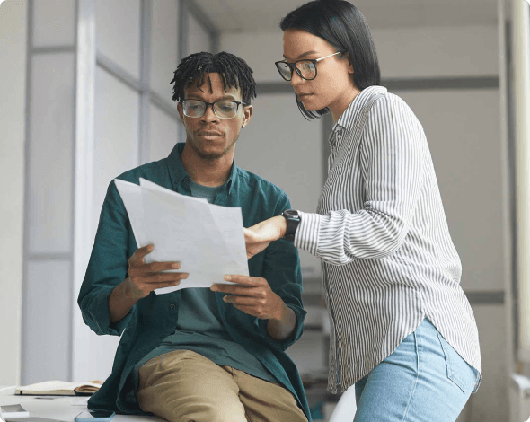 two people looking at a document