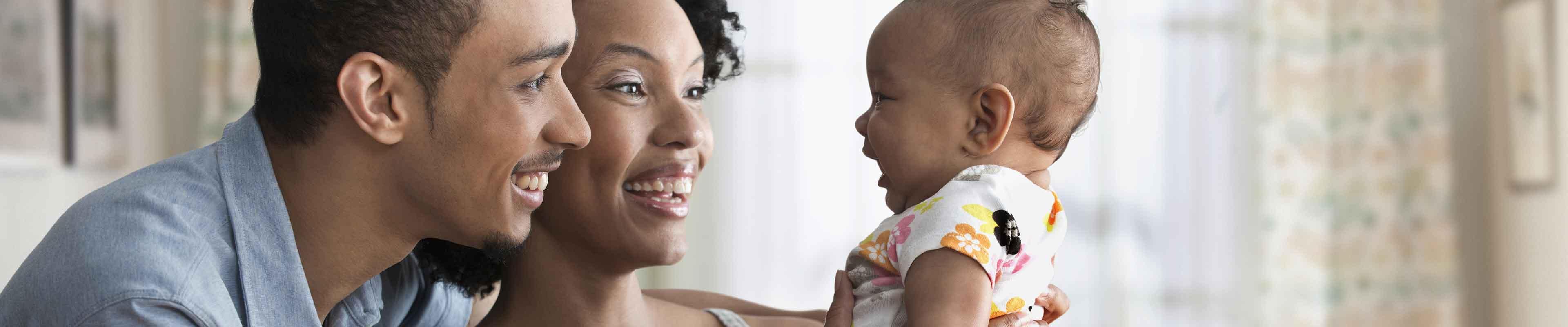 Couple looking at their newborn daughter