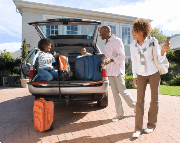 A happy family in front of their home and car. 