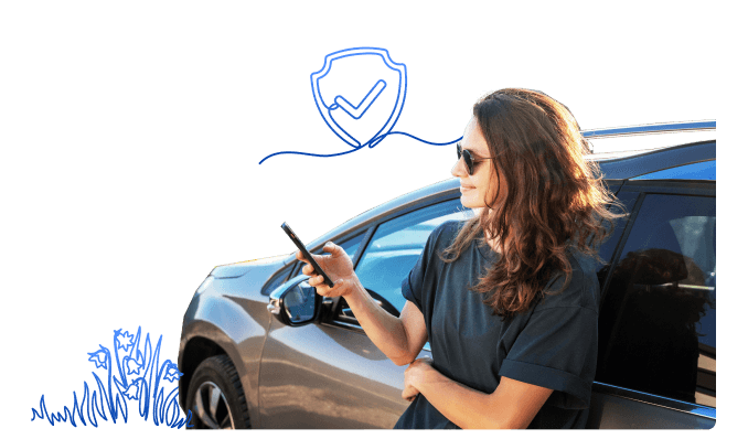 a woman leaning against a car and looking at her phone