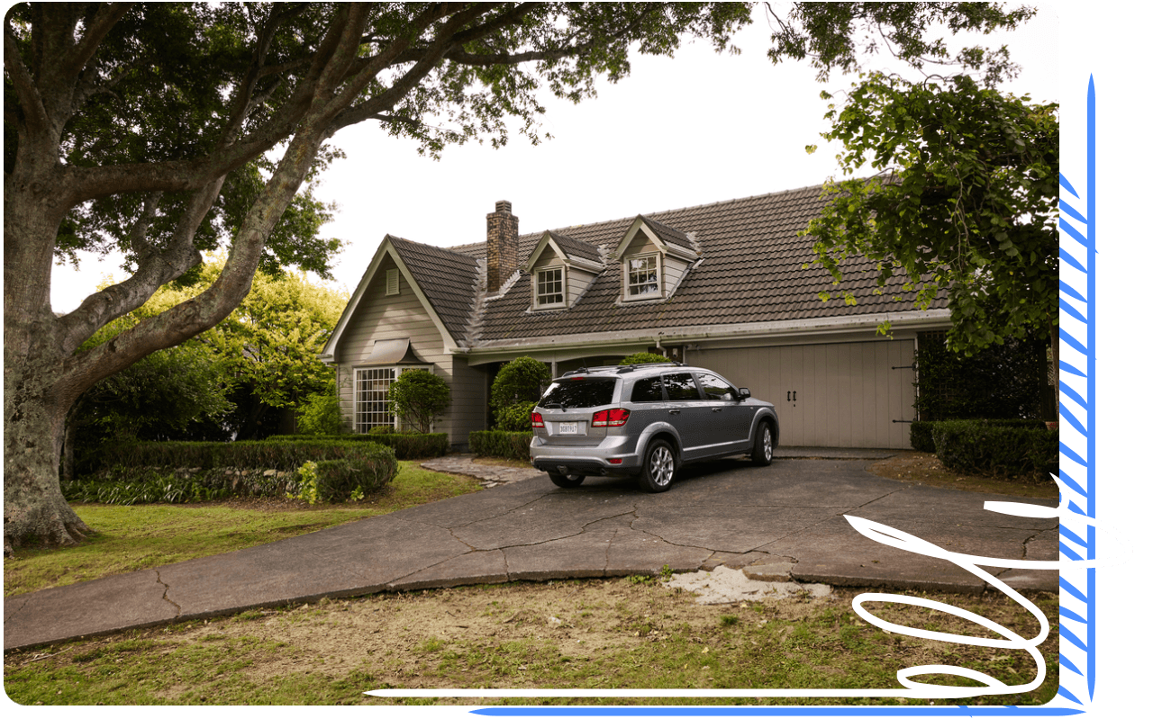 An SUV parked in the driveway of single family home