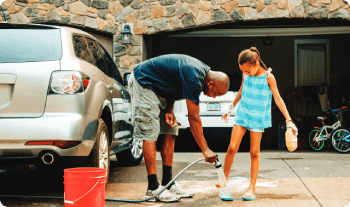 Washing car in a driveway