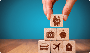 a hand holding a stack of wooden blocks